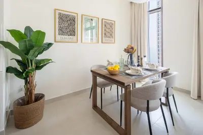 a dining room with a table and a potted plant at Frank Porter - Creek Palace in Dubai
