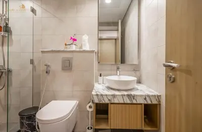 a small bathroom with a toilet and a sink at Serene Canal View 2Bhk 6 pax in Dubai