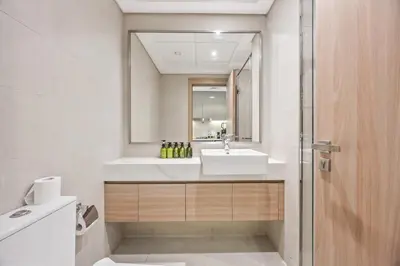a bathroom with a sink and a mirror at Elite Escape - Getaway in Azizi Riviera 13 in Dubai