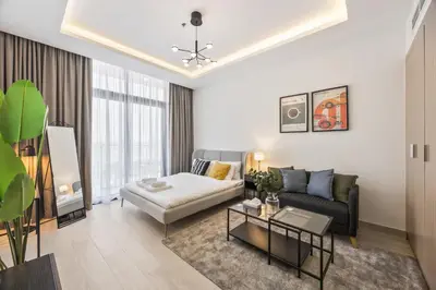 a living room with a couch and a table at Elite Escape - Getaway in Azizi Riviera 13 in Dubai