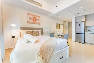 a white bedroom with a large bed and a kitchen at Short Walk to Marina Mall, Marina Walk and JBR Beach, Stunning Marina Views - Bay Central 2, Dubai Marina by Deluxe Holiday Homes in Dubai