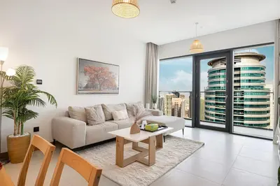 a living room with a couch and a table at Vida Yacht Club Marina 2BDR Sky Suite in Dubai
