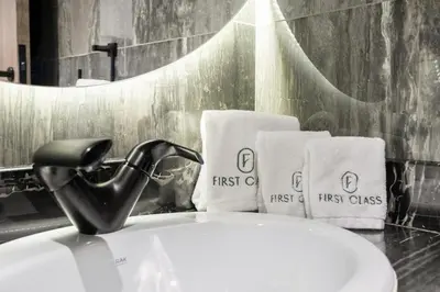 a bathroom with a sink with towels and a faucet at Dubai Arjan Studio - Near Miracle Garden, Hills Mall & Attractions in Dubai