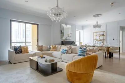 a living room with a couch and a table at High-End Designer Stay l 4 Bed + Maids Room l JBR in Dubai