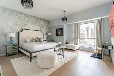 a bedroom with a bed and a living room at High-End Designer Stay l 4 Bed + Maids Room l JBR in Dubai