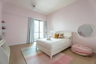 a white bedroom with a white bed and a mirror at High-End Designer Stay l 4 Bed + Maids Room l JBR in Dubai