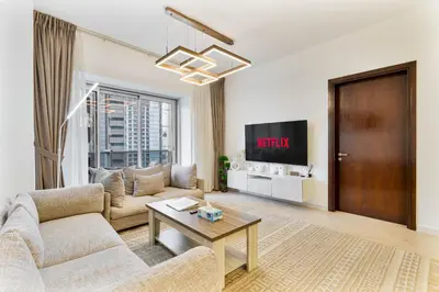 a living room with a couch and a tv at Marina Tower Residences by Baytna in Dubai