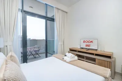 a bedroom with two beds and a sliding glass door at AirDXB - Chic Studio Apartment in Meydan Sleeps 2 with Balcony in Dubai