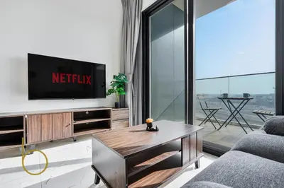 a living room with a tv and a table at Bookable - Alexis Tower, Studio Room with Balcony in Dubai