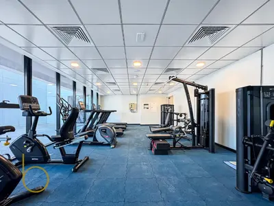 a gym with several treadmills and cardio machines at Bookable - Alexis Tower, Studio Room with Balcony in Dubai