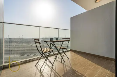 a room with a table and two chairs and a large window at Bookable - Alexis Tower, Studio Room with Balcony in Dubai