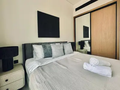a bedroom with a large bed with towels on it at Abstract 1br Flair Gym Pool And Free Parking! in Dubai