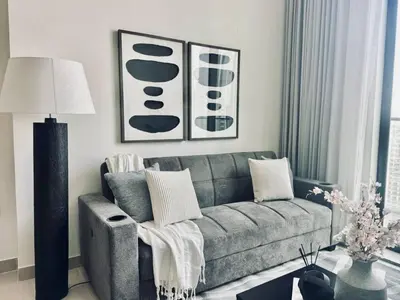 a living room with a couch and a table at Abstract 1br Flair Gym Pool And Free Parking! in Dubai