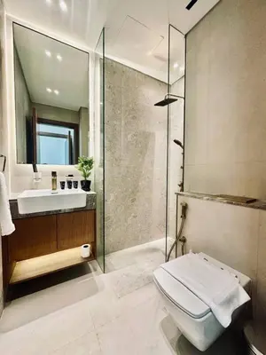 a bathroom with a shower and a toilet and a sink at Abstract 1br Flair Gym Pool And Free Parking! in Dubai