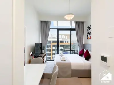 a hotel room with a bed and a balcony at Serenity Studio with Balcony at Azizi Riviera in Dubai
