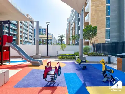 a childrens playground with a slide and slides at Serenity Studio with Balcony at Azizi Riviera in Dubai