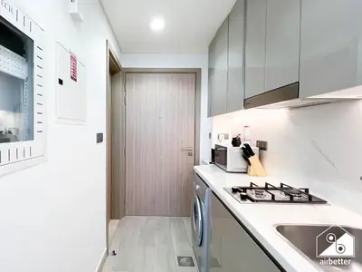a white kitchen with a sink and a stove at Modern Comfort Studio Relax & Unwind in Style in Dubai