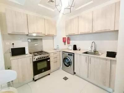 a kitchen with a stove and a dishwasher at SUPERIOR STAY High Floor, Stylish Studio in Business Bay in Dubai