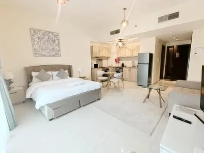 a large bedroom with a bed and a kitchen at SUPERIOR STAY High Floor, Stylish Studio in Business Bay in Dubai