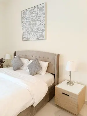 a bedroom with a bed and a table with a lamp at SUPERIOR STAY High Floor, Stylish Studio in Business Bay in Dubai