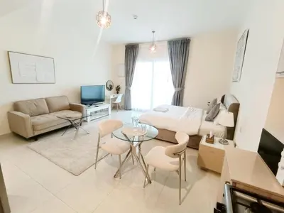 a living room with a couch and a table at SUPERIOR STAY High Floor, Stylish Studio in Business Bay in Dubai