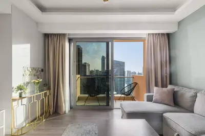 a living room with a couch and a view of a city at Luxury in Dubai Marina Dining Pool Day & Beaches in Dubai