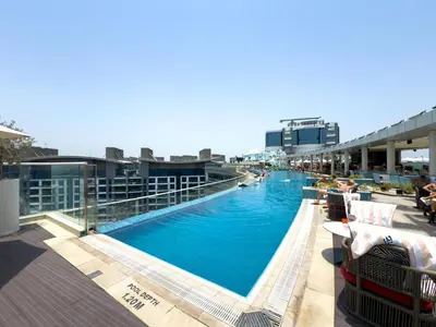 a large swimming pool on top of a building at GuestReady – Infinity Pool and Beach l Palm in Dubai