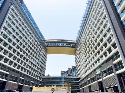 a large building with a bridge in front of it at GuestReady – Infinity Pool and Beach l Palm in Dubai