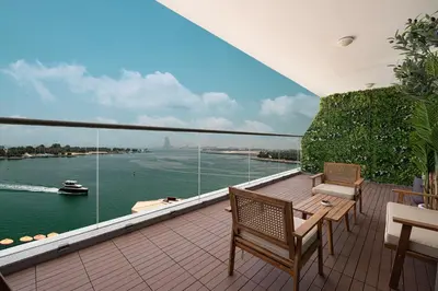 a balcony with chairs and a view of the water at Unreal Patio Private beach Sea View 1BR in Dubai