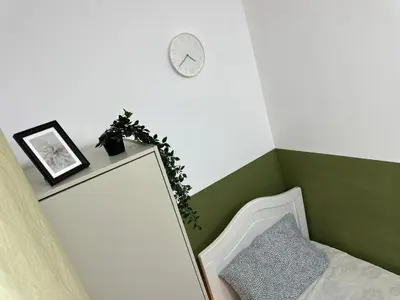 a room with a mirror and a clock on the wall at Tourist Partition Room Barsha Heights Tecom in Dubai