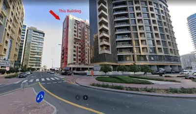 a city street with a large building in the background at Tourist Partition Room Barsha Heights Tecom in Dubai