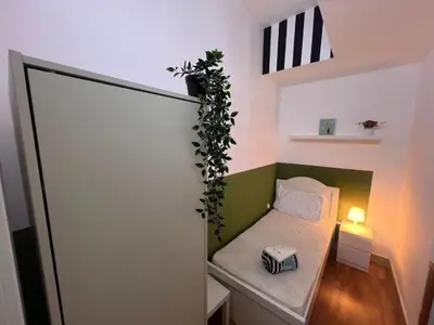 a small room with a bed with a plant on it at Tourist Partition Room Barsha Heights Tecom in Dubai