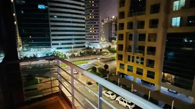 a view from a balcony of a city at night at Charming Partition Room Barsha Heights Tecom in Dubai