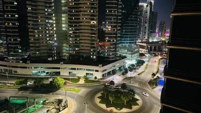 a view of a city at night with buildings at Divine Partition Room Barsha Heights Tecom in Dubai