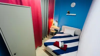 a small room with a bed and a mirror at Divine Partition Room Barsha Heights Tecom in Dubai