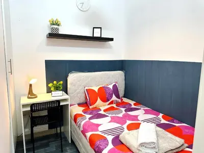 a small bedroom with a bed and a desk at Magnificent Partition Room in Barsha Heights Tecom in Dubai