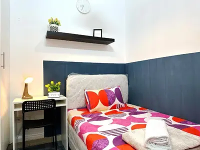 a small bedroom with a bed and a desk at Magnificent Partition Room in Barsha Heights Tecom in Dubai