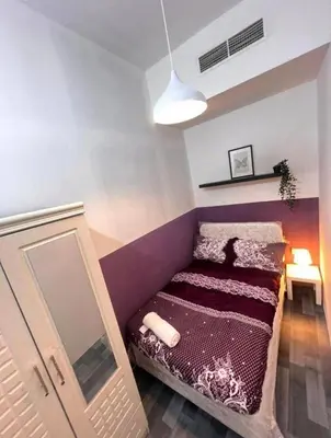a small room with a bed and a mirror at Excellent Partition Room In Barsha Heights Tecom in Dubai