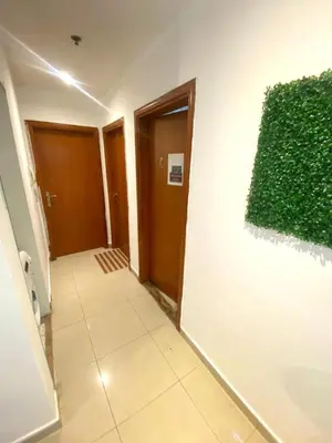 a hallway with a green painting on a wall at Excellent Partition Room In Barsha Heights Tecom in Dubai