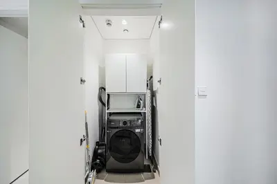 a washing machine in a room with white walls at Spacious 3BD apartment at Creek Beach, Dubai in Dubai