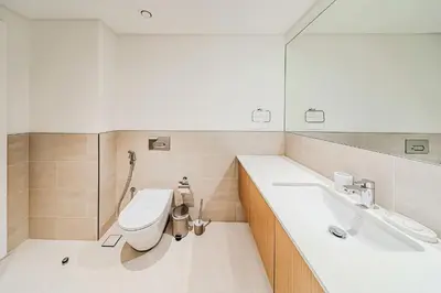 a bathroom with a toilet and a sink at Spacious 3BD apartment at Creek Beach, Dubai in Dubai