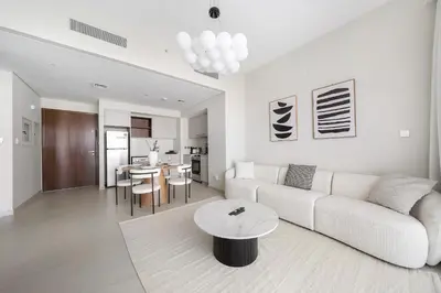 a living room with a couch and a table at VayK - Classy 1BR Near the Lagoon in Creek Harbour in Dubai