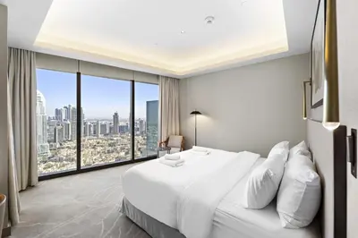 a bedroom with a large white bed and a large window at VayK - Exceptional 2BR at Address Dubai Opera in Dubai