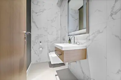 a white bathroom with a sink and a mirror at VayK - Exceptional 2BR at Address Dubai Opera in Dubai