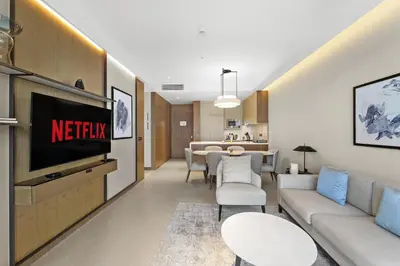 a living room with a couch and a tv at VayK - Exceptional 2BR at Address Dubai Opera in Dubai