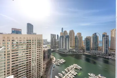 a view of a river in a city with tall buildings at VayK - Luxury 1BR with Marina View in Dubai