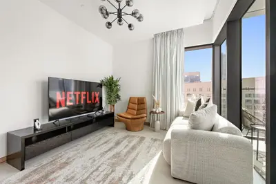 a living room with a tv and a couch at VayK - Luxury 1BR with Marina View in Dubai