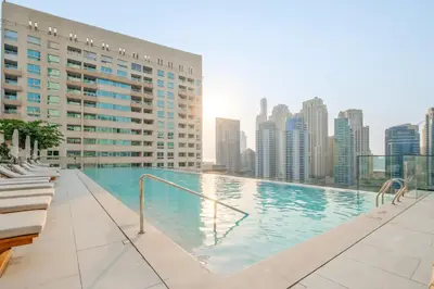 a swimming pool on the roof of a building at VayK - Luxury 1BR with Marina View in Dubai