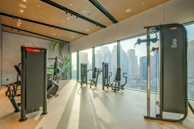 a gym with treadmills and cardio equipment in a building at VayK - Luxury 1BR with Marina View in Dubai