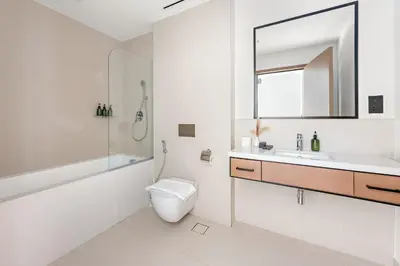 a bathroom with a toilet and a sink and a mirror at VayK - Luxury 1BR with Marina View in Dubai